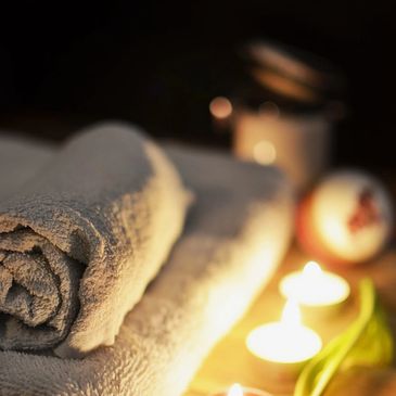 Folded towels and candles in a calm spa setting