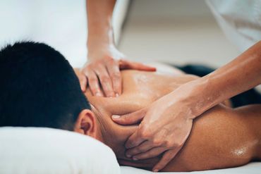 Therapist performing a focused shoulder massage
